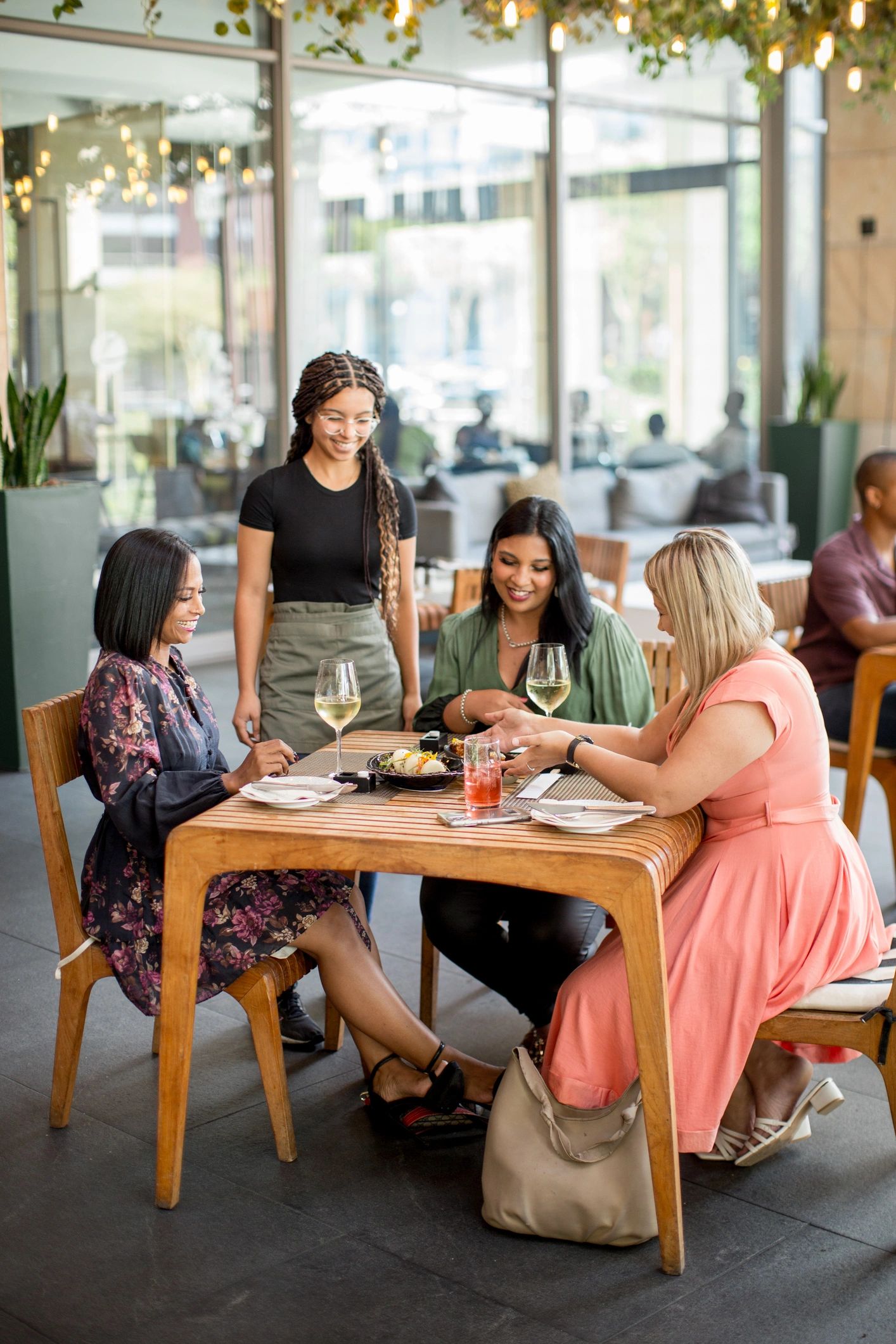 Guests receiving dishes in a refined restaurant setting